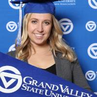Future graduate poses with GV flag at Gradfest